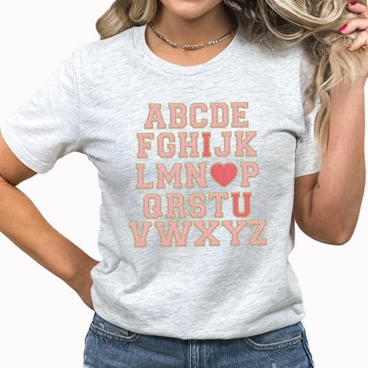Alphabet I Love You Graphic Tee | Faux Chenille | Fri-Yay Teacher | School | Valentines | I Heart You | Pink | Printed Tee | Laying Tee